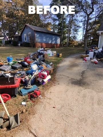 Driveway covered with estate cleanout items before haul